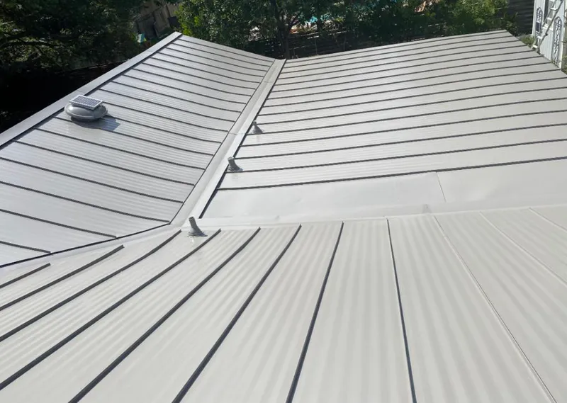 Solar attic fan installed on a metal roof for Roof Ventilation in Pine Hill